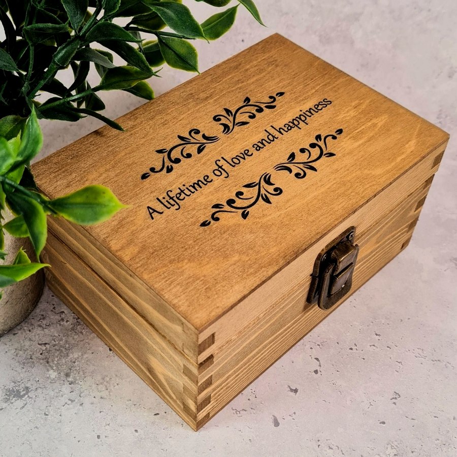 Open wooden box with velvet lining and engraved quote