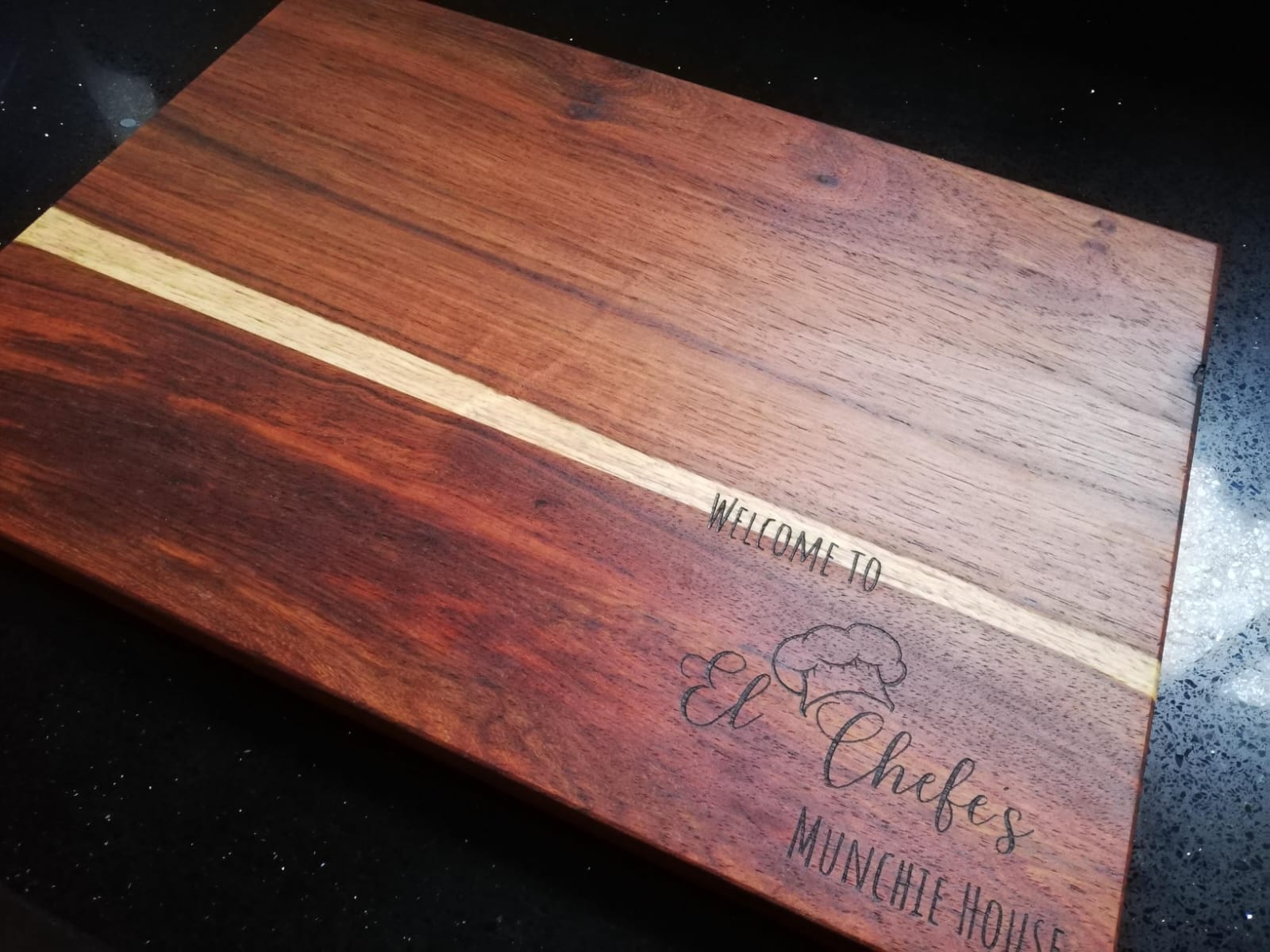 Deep-stained cutting board with engraved quote