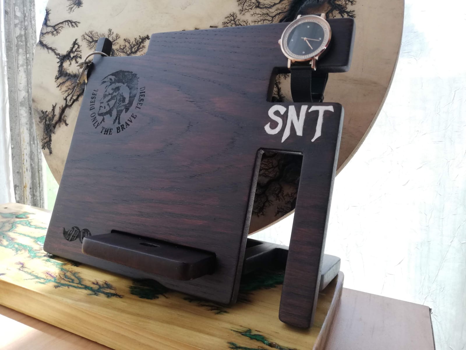 Dark-stained wooden desk valet holding watch and daily accessories